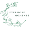 A minimalist logo featuring a green line-art botanical wreath with the words 'EVERMORE MOMENTS' in green serif text, centered on a solid white background.